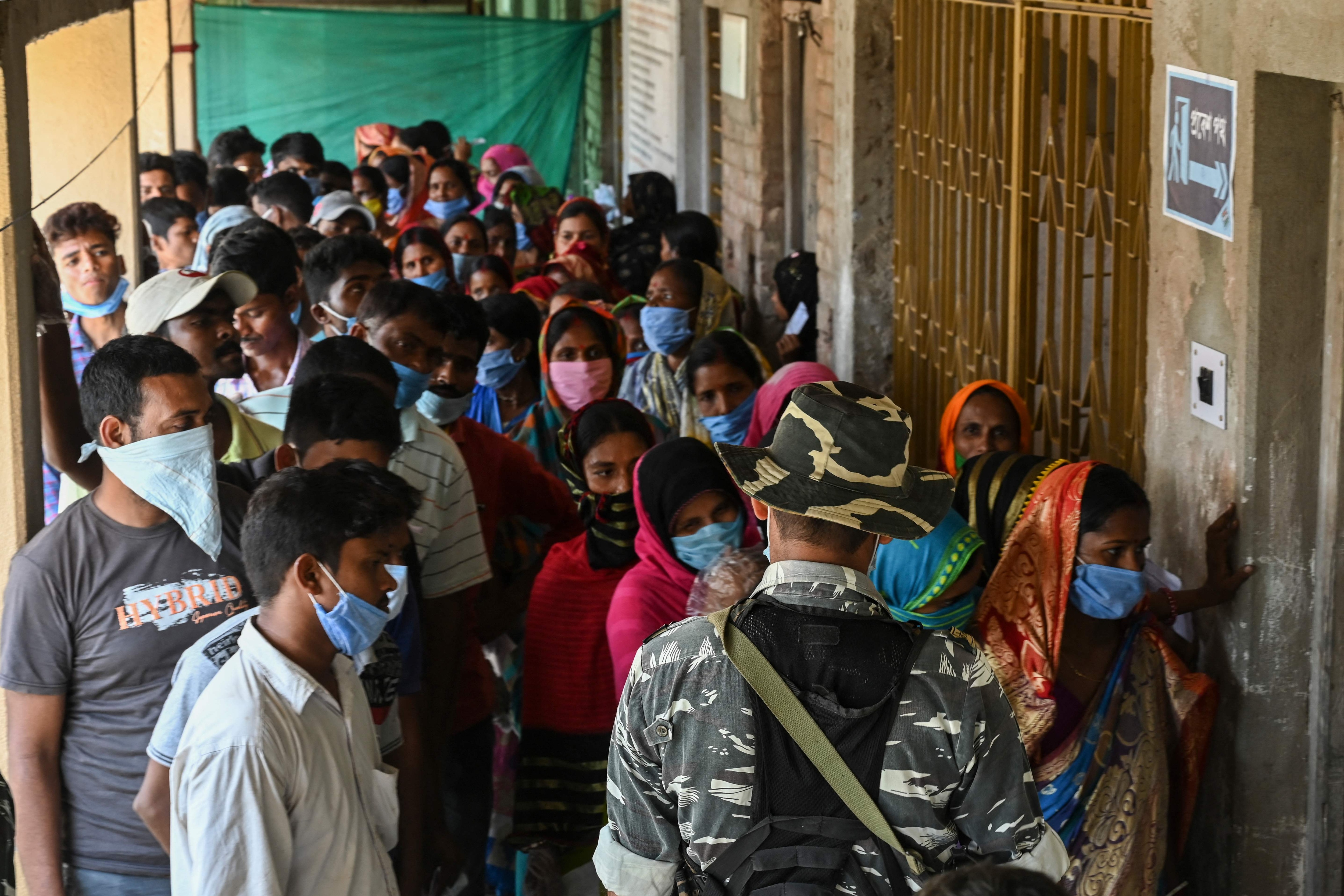 Voters stand in a line to cast their vote at a polling station during Phase 2 of West Bengal's legislative election in Nandigram on April 1, 2021. (AFP) Voters stand in a line to cast their vote at a polling station during Phase 2 of West Bengal's legislative election in Nandigram on April 1, 2021. (AFP)