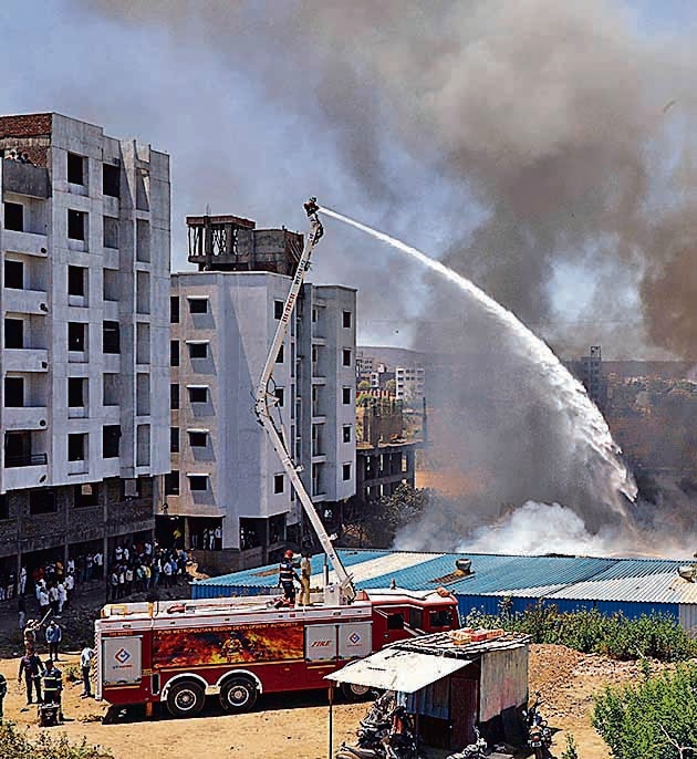 Firemen in action after four small factories in a shed caught fire at Narhegoan in Pune, on March 31. (RAHUL RAUT/HT) Firemen in action after four small factories in a shed caught fire at Narhegoan in Pune, on March 31. (RAHUL RAUT/HT)