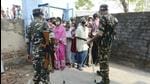 Security personnel stand guard as citizens wait to cast their vote during the second phase of West Bengal assembly polls, at Gosaba in South 24 Parganas district, Thursday, April 1. (PTI)