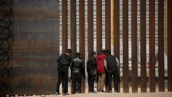 Migrants look through the border wall after crossing the Rio Bravo river, seen from Ciudad Juarez, Mexico. (Reuters) Migrants look through the border wall after crossing the Rio Bravo river, seen from Ciudad Juarez, Mexico. (Reuters)