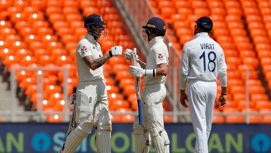Ollie Pope and Ben Stokes talk as India captain Virat Kohli passes by (REUTERS)