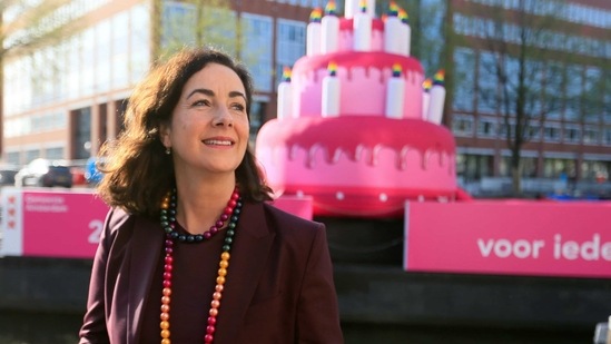Amsterdam Mayor Femke Halsema is seen in front a giant inflatable cake as it is floated on a canal to celebrate the 20th anniversary of the world's first legally-recognised same-sex wedding, in Amsterdam, Netherlands, April 1, 2021. (REUTERS)