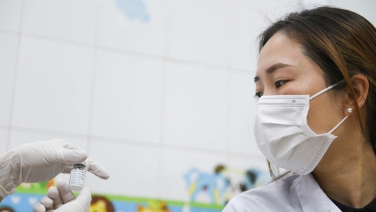 FILE PHOTO: A doctor looks at the vial before receiving a vaccine, as Vietnam starts its official rollout of AstraZeneca's coronavirus disease (COVID-19) vaccine for health workers, at Hai Duong Hospital for Tropical Diseases, Hai Duong province, Vietnam, March 8, 2021. REUTERS/Thanh Hue/File Photo (REUTERS)