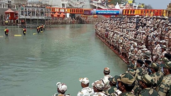 Paramilitary personnel offer prayers for a safe and unhindered Kumbh fair amid rising cases of coronavirus disease (Covid-19) at Har ki Pauri in Haridwar. As many as 12,000 police and 400 paramilitary force personnel have been deployed at the site to maintain law and order and ensure that devotees adhere to Covid-19 norms. (ANI photo) Paramilitary personnel offer prayers for a safe and unhindered Kumbh fair amid rising cases of coronavirus disease (Covid-19) at Har ki Pauri in Haridwar. As many as 12,000 police and 400 paramilitary force personnel have been deployed at the site to maintain law and order and ensure that devotees adhere to Covid-19 norms. (ANI photo)