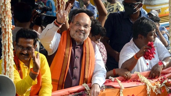 Union Home Minister Amit Shah shows victory sign during a roadshow at Baruipur constituency for his party candidate ahead of state legislative assembly election, in South 24 Parganas district on Friday. (ANI Photo) Union Home Minister Amit Shah shows victory sign during a roadshow at Baruipur constituency for his party candidate ahead of state legislative assembly election, in South 24 Parganas district on Friday. (ANI Photo)