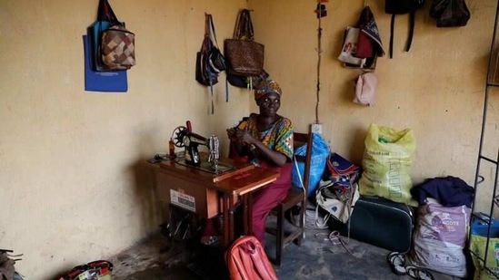 Ajayi working in her shop in Ilorin on March 25. As a child, she worked in her aunt's shop instead of attending school. She now runs her own business making and selling purses and bags, but believes her inability to read or write is holding her back.(Temilade Adelaja / REUTERS)
