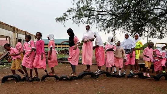 Students stand on tyres in the playground of Ilorin Grammar school in Ilorin on March 24. "She has been coping well with the other students: playing together, talking together and discussing things together," Busari told Reuters.(Temilade Adelaja / REUTERS)