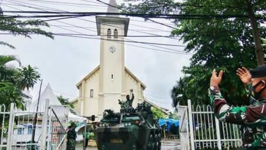 A soldier guides an armored vehicle as they are deployed to guard the Sacred Heart of Jesus Cathedral which was attacked by suicide bomb on March 28, ahead of Mass on Good Friday, Makassar,(AP)