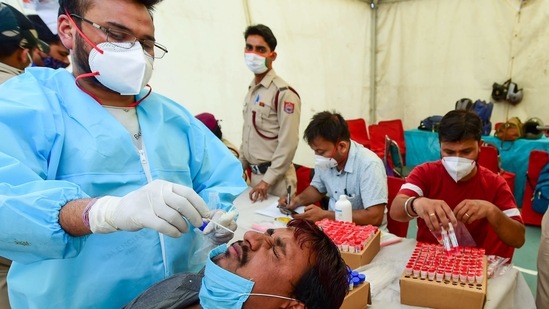 A health worker collects a nasal sample from a passenger for Covid-19 test, amid coronavirus pandemic, in New Delhi. (PTI) A health worker collects a nasal sample from a passenger for Covid-19 test, amid coronavirus pandemic, in New Delhi. (PTI)