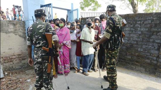 Security personnel stand guard as citizens wait to cast their vote during the second phase of West Bengal assembly polls, at Gosaba in South 24 Parganas district, Thursday, April 1. (PTI) Security personnel stand guard as citizens wait to cast their vote during the second phase of West Bengal assembly polls, at Gosaba in South 24 Parganas district, Thursday, April 1. (PTI)