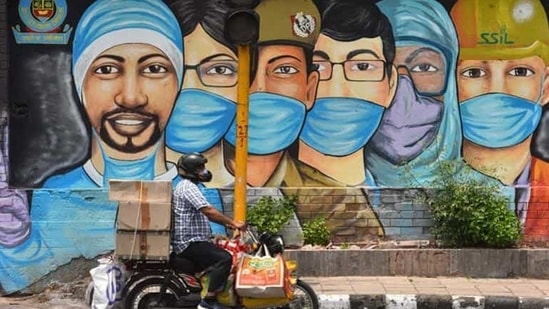 A motorist passes by a mural of frontline workers against coronavirus at RK Puram in New Delhi on July 25. Delhi’s Covid-19 recoveries have outstripped new cases on almost all days this month barring a few exceptions, after ramped-up containment and testing efforts over the past month or so. (Sanchit Khanna / HT Photo) A motorist passes by a mural of frontline workers against coronavirus at RK Puram in New Delhi on July 25. Delhi’s Covid-19 recoveries have outstripped new cases on almost all days this month barring a few exceptions, after ramped-up containment and testing efforts over the past month or so. (Sanchit Khanna / HT Photo)