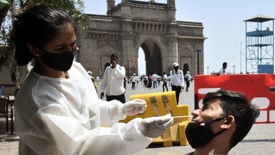 A health care worker collects a nasal sample from a man for COVID-19 testing, amid the rise in cases, in Mumbai on Friday. (ANI Photo) A health care worker collects a nasal sample from a man for COVID-19 testing, amid the rise in cases, in Mumbai on Friday. (ANI Photo)