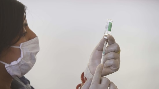 A health worker preparing a dose of a Covid-19 vaccine from a Covishield vaccine vial, during a camp in Sector 15 Phase II Community Centre in Gurugram. (Vipin Kumar /HT PHOTO) A health worker preparing a dose of a Covid-19 vaccine from a Covishield vaccine vial, during a camp in Sector 15 Phase II Community Centre in Gurugram. (Vipin Kumar /HT PHOTO)