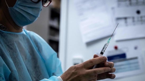 A member of the medical staff prepares a dose of the Pfizer/BioNTech Covid-19 vaccine at the Palais des Sports venue in Lyon, hosting a Covid-19 vaccination centre, on March 29, 2021 as France faces a new wave of infections to the novel coronavirus. (Photo by JEAN-PHILIPPE KSIAZEK / AFP)(AFP)