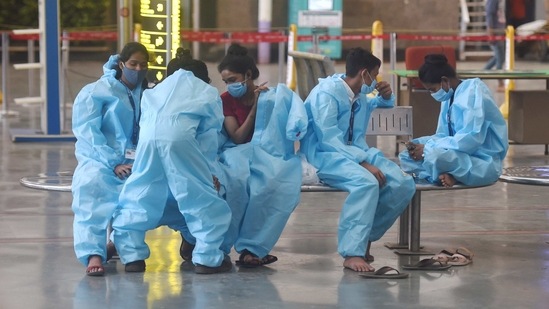 Health workers take a break after collecting samples from passengers for COVID-19 test, at the Chhatrapati Shivaji Maharaj terminus in Mumbai. (PTI Photo) Health workers take a break after collecting samples from passengers for COVID-19 test, at the Chhatrapati Shivaji Maharaj terminus in Mumbai. (PTI Photo)