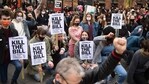 Protestors hold placards as they sit on the street during a Kill The Bill protest against the Police, Crime, Sentencing and Courts Bill, in Manchester, north west England.(AFP)