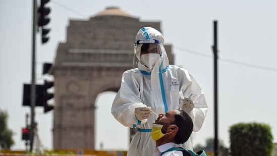 A healthcare worker collects the swab sample for Covid-19 testing from a person at India Gate in New Delhi. (ANI Photo) A healthcare worker collects the swab sample for Covid-19 testing from a person at India Gate in New Delhi. (ANI Photo)
