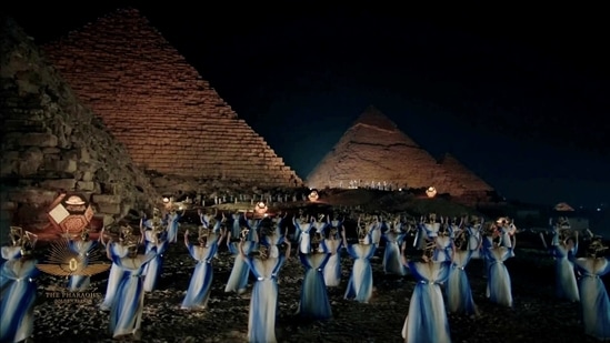 Artists perform near pyramids during the Pharaohs’ Golden Parade in Cairo on April 3. Authorities shut down roads along the Nile for the elaborate ceremony, designed to drum up interest in Egypt's rich collections of antiquities when tourism has almost entirely stalled because of Covid-19 related restrictions, Reuters reported.(Host Broadcaster via REUTERS)