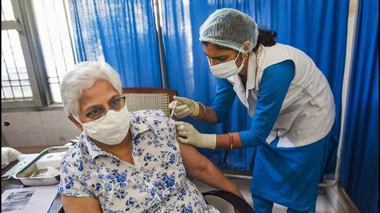 A medic administers the Covid-19 vaccine to a senior citizen in Gurugram on Wednesday. (PTI) A medic administers the Covid-19 vaccine to a senior citizen in Gurugram on Wednesday. (PTI)