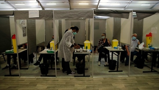 Patients receive Pfizer and Moderna's COVID-19 vaccine in a vaccination site in Sarcelles, outside Paris on Sunday. (AP Photo ) Patients receive Pfizer and Moderna's COVID-19 vaccine in a vaccination site in Sarcelles, outside Paris on Sunday. (AP Photo )