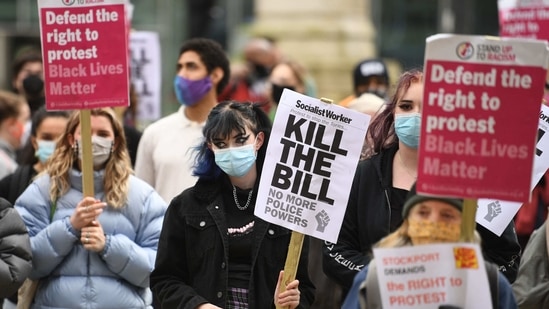 Protestors carry placards during a Kill The Bill protest against the Police, Crime, Sentencing and Courts Bill, in Manchester, north west England on March 27, 2021. (AFP Photo ) Protestors carry placards during a Kill The Bill protest against the Police, Crime, Sentencing and Courts Bill, in Manchester, north west England on March 27, 2021. (AFP Photo )