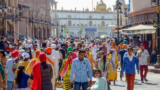People, not adhering to Covid-19 norms, walking at the Heritage Street near Golden Temple, Amritsar on Saturday. (PTI) People, not adhering to Covid-19 norms, walking at the Heritage Street near Golden Temple, Amritsar on Saturday. (PTI)