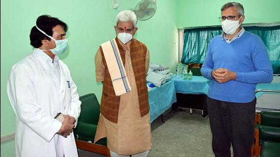 Lieutenant governor Manoj Sinha with National Conference leader Omar Abdullah at SKIMS in Srinagar on Sunday. (ANI)