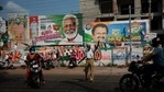 A policeman directs traffic standing before a display of election campaign posters of various candidates at Nemom constituency in Thiruvanathapuram, Kerala state, India, Saturday, April 3, 2021. The southern state goes to polls on April 6. (AP Photo/R S Iyer)(AP) A policeman directs traffic standing before a display of election campaign posters of various candidates at Nemom constituency in Thiruvanathapuram, Kerala state, India, Saturday, April 3, 2021. The southern state goes to polls on April 6. (AP Photo/R S Iyer)(AP)