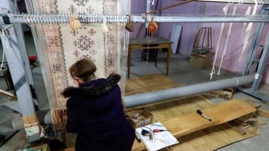 Hate Ora or 'Aunt Hate', 64, as everyone knows her, weaving a carpet in Kukes town, northeastern Albania, Friday, March 12, 2021. Albania once had 13 former state-run factories that produced carpets, rugs, fez hats, felt folk costumes and other handicrafts. Kukes, a town northeast of the capital, Tirana, alone employed more than 1,200 women as weavers. When the country's communist era ended in 1990, the local factory closed. (AP)