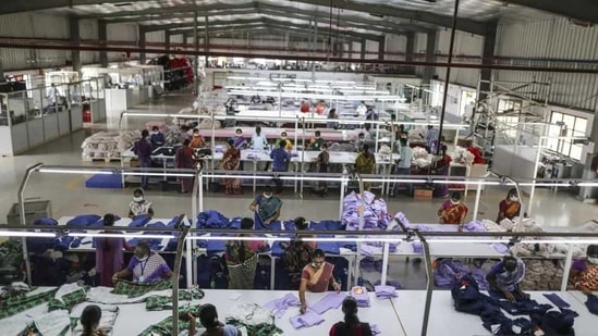 Employees handle garments on the cutting division production line at the CBC Fashions Pvt. factory in Tiruppur, Tamil Nadu. (Bloomberg)