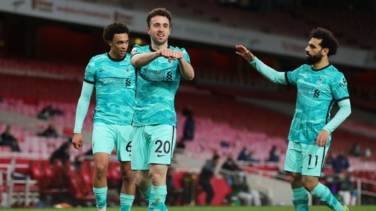 Soccer Football - Premier League - Arsenal v Liverpool - Emirates Stadium, London, Britain - April 3, 2021 Liverpool's Diogo Jota celebrates scoring their first goal with Trent Alexander-Arnold and Mohamed Salah Pool via REUTERS/Catherine Ivill EDITORIAL USE ONLY. No use with unauthorized audio, video, data, fixture lists, club/league logos or 'live' services. Online in-match use limited to 75 images, no video emulation. No use in betting, games or single club /league/player publications. Please contact your account representative for further details.(Pool via REUTERS)