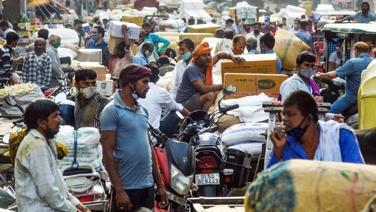 People seen in large numbers violating Covid-19 guidelines amid rising cases of Coronavirus, at Spice Market, in Old Delhi on Monday. (ANI photo) People seen in large numbers violating Covid-19 guidelines amid rising cases of Coronavirus, at Spice Market, in Old Delhi on Monday. (ANI photo)