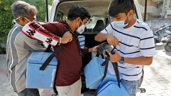 Healthcare workers unload boxes containing vials of Covid-19 vaccine, in Ahmedabad, on April 2. Prime Minister Narendra Modi, in a meeting on April 4 morning, said states must take the necessary steps and impose the required restrictions to contain the outbreak, HT reported.(Amit Dave / REUTERS)
