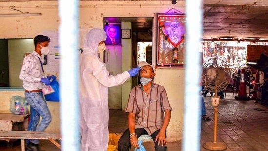 A heath worker conducts Covid-19 testing of a man at Dadar market, amid a surge in coronavirus cases across Maharashtra, in Mumbai. A heath worker conducts Covid-19 testing of a man at Dadar market, amid a surge in coronavirus cases across Maharashtra, in Mumbai.