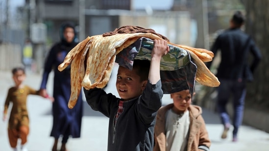 An Afghan boy carries bread on his head in Kabul, Afghanistan, Monday, March 29, 2021. (AP) An Afghan boy carries bread on his head in Kabul, Afghanistan, Monday, March 29, 2021. (AP)