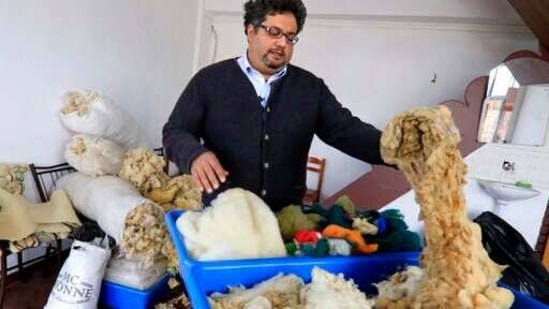 Elias Mazlum holds cotton at his training center in Kukes town, northeastern Albania, Friday, March 12, 2021. Albania once had 13 former state-run factories that produced carpets, rugs, fez hats, felt folk costumes and other handicrafts. Kukes, a town northeast of the capital, Tirana, alone employed more than 1,200 women as weavers. When the country's communist era ended in 1990, the local factory closed. (AP Photo/Hektor Pustina)(AP)