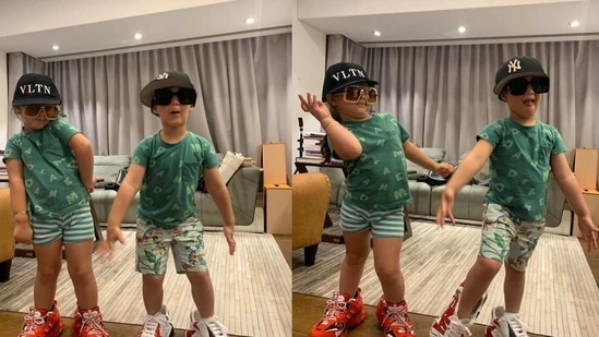 Karan Johar's children Yash and Roohi pose in his shoes. 