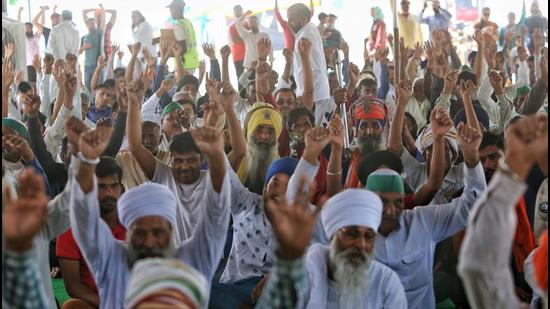 Farmers shout slogans during their ongoing protest against farm laws, at Ghazipur border in New Delhi. (ANI)