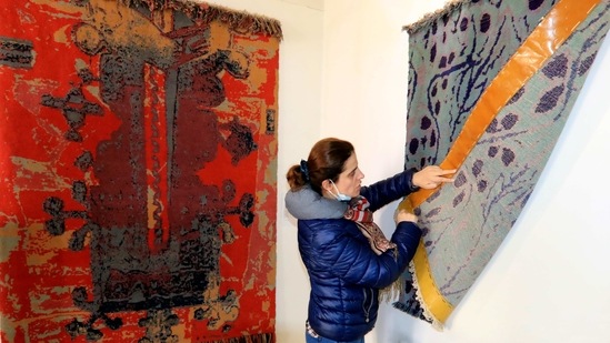 Blerina Koljini, an associate professor of textile and fashion, shows a carpet in Kukes town, northeastern Albania, Friday, March 12, 2021. (AP)