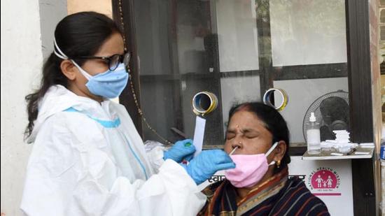 File photo: A healthcare worker takes swab sample from a woman for Covid-19 testing. (Santosh Kumar /Hindustan Times) File photo: A healthcare worker takes swab sample from a woman for Covid-19 testing. (Santosh Kumar /Hindustan Times)