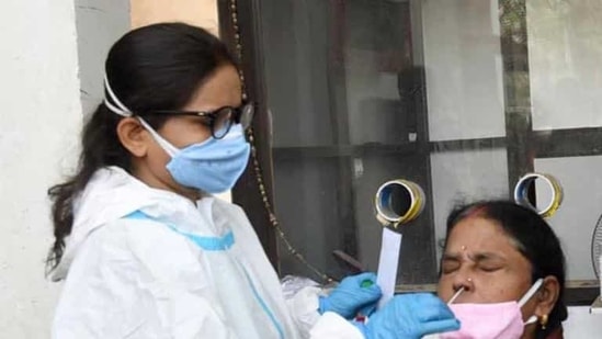 File photo: A healthcare worker takes swab sample from a woman for Covid-19 testing. (Santosh Kumar/HT Photo) File photo: A healthcare worker takes swab sample from a woman for Covid-19 testing. (Santosh Kumar/HT Photo)