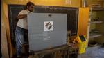 An official makes preparations at a polling station on the eve of third phase of assembly election in Guahati, Assam. (AP) An official makes preparations at a polling station on the eve of third phase of assembly election in Guahati, Assam. (AP)