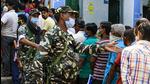 Paramilitary soldiers manage a queue at a polling booth during third phase of West Bengal state elections in Baruipur, South 24 Pargana district, on Tuesday. (AP)