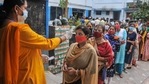Voters undergo thermal screening for as part of precautions against Covid-19 as they stand in a queue to cast their votes at a polling station during the third phase of West Bengal Assembly elections, at Baruipur in South 24 Parganas district. (PTI) Voters undergo thermal screening for as part of precautions against Covid-19 as they stand in a queue to cast their votes at a polling station during the third phase of West Bengal Assembly elections, at Baruipur in South 24 Parganas district. (PTI)