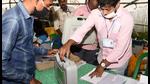 Polling officials collecting the Electronic Voting Machines (EVMs) and other necessary things required for the West Bengal assembly election, at a distribution centre, in Uluberia on Monday. (ANI)