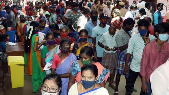 Voters stand in queues as they wait to cast their vote during the assembly elections in Chennai on Tuesday. (ANI)