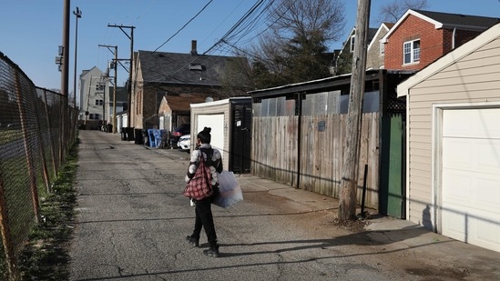 A person walks through an alley days after a fatal shooting of a 13-year-old boy by a Chicago Police officer in Chicago.(AP) A person walks through an alley days after a fatal shooting of a 13-year-old boy by a Chicago Police officer in Chicago.(AP)