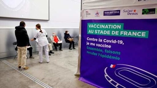 People wait before being vaccinated against Covid-19 at the Stade de France stadium, outside Paris on Tuesday. (AP Photo) People wait before being vaccinated against Covid-19 at the Stade de France stadium, outside Paris on Tuesday. (AP Photo)