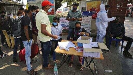 The worrying trend of increasing daily new infections in the state has been observed since the first week of March 2021. In picture - Travellers gather next to health workers to get tested for Covid-19 outside a bus station in Bengaluru. (AP) The worrying trend of increasing daily new infections in the state has been observed since the first week of March 2021. In picture - Travellers gather next to health workers to get tested for Covid-19 outside a bus station in Bengaluru. (AP)