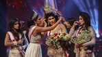 Winner of Mrs. Sri Lanka 2020 Caroline Jurie (second left) removes the crown of 2021 winner Pushpika de Silva (C) as she is disqualified.(AFP) Winner of Mrs. Sri Lanka 2020 Caroline Jurie (second left) removes the crown of 2021 winner Pushpika de Silva (C) as she is disqualified.(AFP)